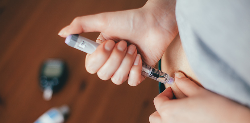 Woman doing injection with insulin pen